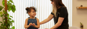 smiling and relaxed child patient chatting with one of our practitioners