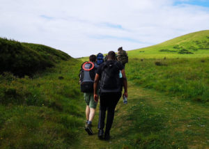Ty and fellow hikers walking across the South Downs in full gear with backpacks