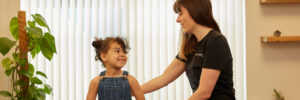 Audrey Buot in a relaxed consultation with a smiling young child patient