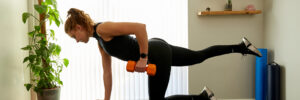a patient performs stretches with weights in one of our clinics