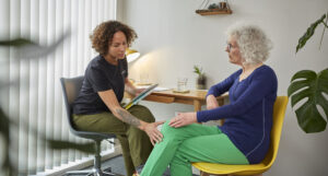 Practitioner discussing the stages of healing with a female patient